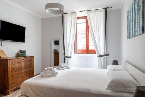 - une chambre blanche avec un grand lit et une fenêtre dans l'établissement Appartamento Adara by Wonderful Italy, à Bari