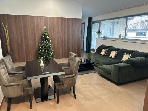 a living room with a christmas tree and a table at Apartmán s vírivkou v centre - Banská Bystrica in Banská Bystrica