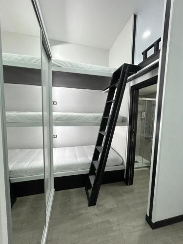 a room with two bunk beds and a mirror at Cotrades 1 En San Blas-Canillejas in Madrid