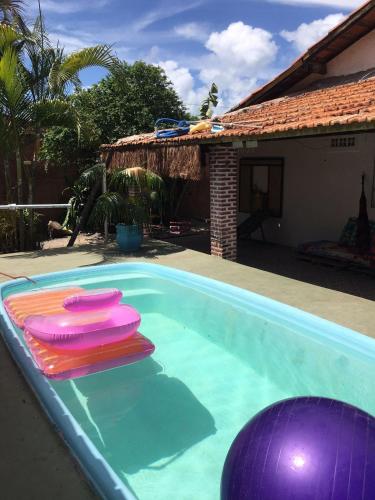 a swimming pool with some frisbees in it at Hostel Itaparica in Itaparica Town