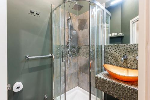 a bathroom with a glass shower with a orange sink at Luxury Three Bedrooms flat in Roma Center in Rome