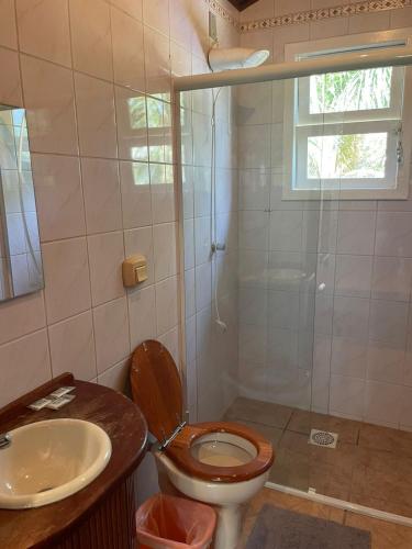 a bathroom with a toilet and a sink and a shower at Ilha Náutica in Florianópolis