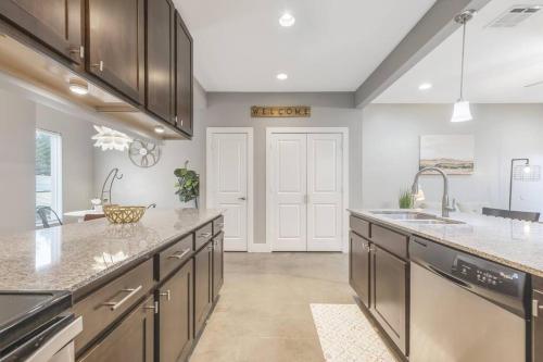 a kitchen with gray cabinets and a large counter top at Cozy 2 Bed Townhome near the Hospital in Lafayette