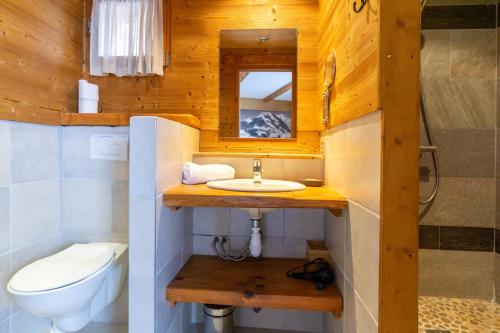 a bathroom with a sink and a toilet at Chalet Lyskamm in Montvalezan
