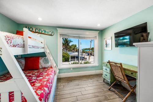 a bedroom with a bunk bed and a window at Bay Vista at Bayside Bungalow in Anna Maria