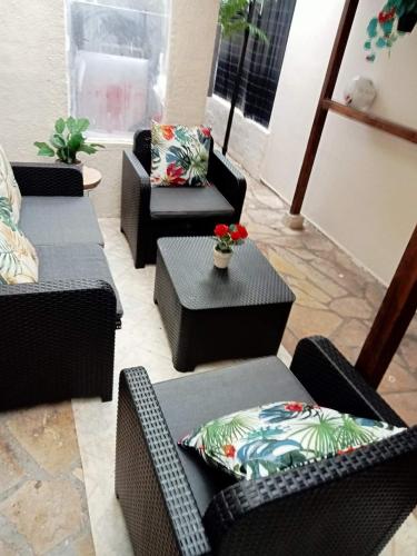 a living room with couches and a table with a flowerussion at PARADIS CHAMBRES D'HÔTES PROCHE PARIS - AÉROPORT CHARLES DE GAULLE AIRPORT - PARC DES EXPOSITION VILLEPINTE - DYSNAYLAND PARIS. in Tremblay En France