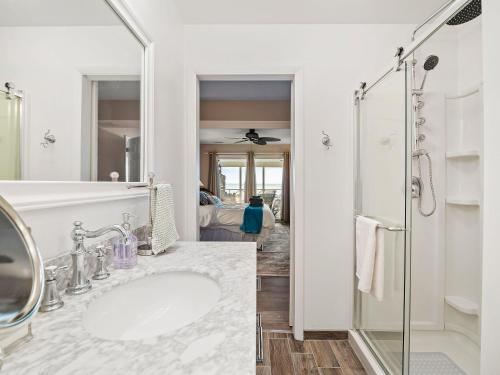 a white bathroom with a sink and a shower at Oakwood Beach - Lake Front - Geneva-On-The-Lake in Ashtabula