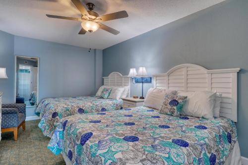 a bedroom with two beds and a ceiling fan at 2501 S Ocean Blvd, 0505 - Ocean Front Sleeps 6 in Myrtle Beach