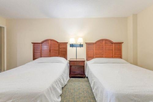 two beds sitting next to each other in a room at 2501 S Ocean Blvd, 0707 - Ocean Front Sleeps 6 in Myrtle Beach