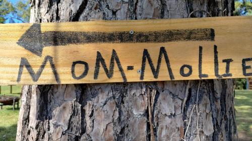 a sign on a tree that reads mommama at Khushatta Hills Ranch Glamping - Mom Mollie in Coldspring