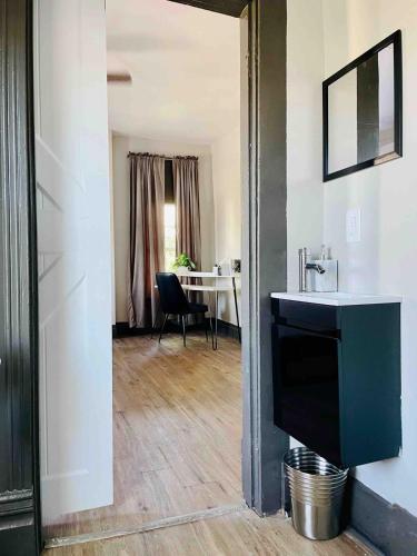 a living room with a sink and a desk at Suite Home Indiana Apartments in Evansville