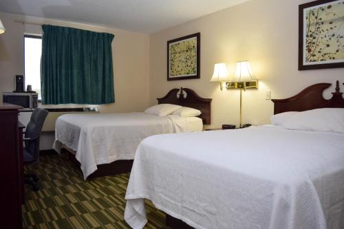 a hotel room with two beds and a window at Corning Inn in Painted Post