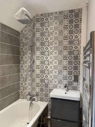 a bathroom with a shower and a sink and a tub at Modern house in leafy suburban Birmingham city in Birmingham