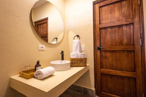 a bathroom with a sink and a mirror at Casa Noa Colonial Rooms By SOHO in Cartagena de Indias