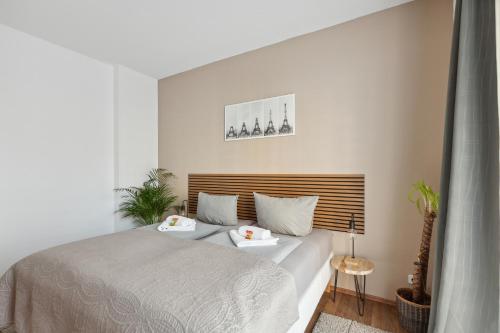 a bedroom with a bed with two pillows on it at Aura - Nula #1 -2 Zimmer, 4 Betten, Küche, Balkon, Waschmaschine in Merseburg