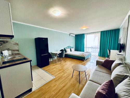a living room with a couch and a table and a kitchen at Apartments in Panorama Beach Vigo Nessebar in Nesebar
