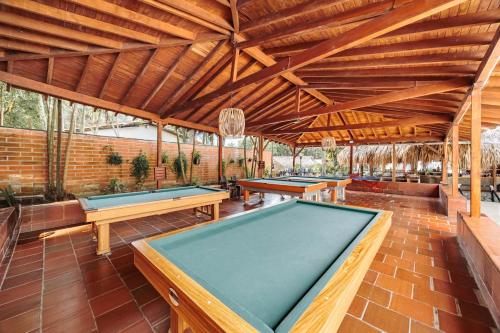 a pool table in a pavilion with ping pong tables at Hotel Quimbaya in San Jerónimo