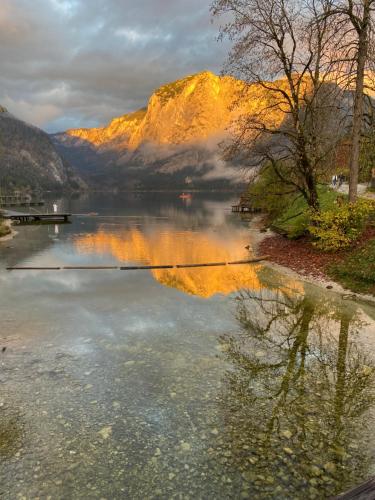 a reflection of a mountain in a body of water at Obersdorfer Hof in Bad Mitterndorf
