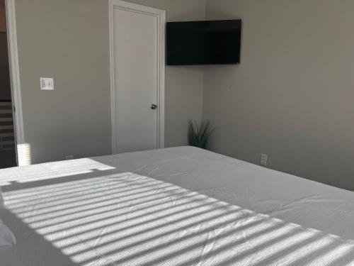a bedroom with a bed with a television on the wall at 1408 Perrin Dr, Unit D - Ocean Walk Sleeps 8 in Myrtle Beach
