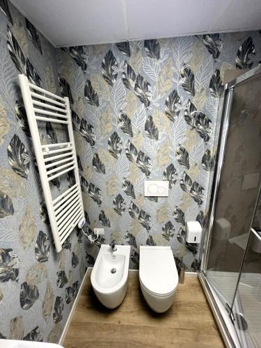 a bathroom with a toilet and a sink and a shower at ROME'S GLORIA HOTEL in Rome