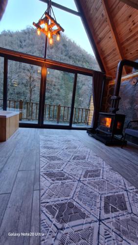 a large room with a stone floor and a fireplace at Golden Rose Bungalov in Ardeşen