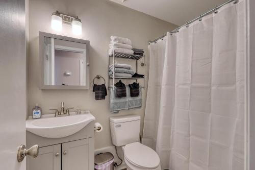 a bathroom with a toilet and a sink and a mirror at 1408 Perrin Dr, Unit D - Ocean Walk Sleeps 8 in Myrtle Beach