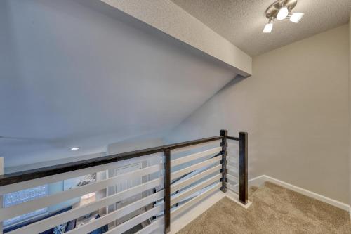 a staircase with white walls and a railing at 1408 Perrin Dr, Unit D - Ocean Walk Sleeps 8 in Myrtle Beach