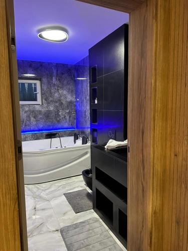a bathroom with a purple ceiling and a bath tub at Apartament de Lux André in Sibiu