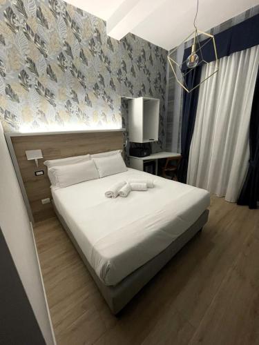 a bedroom with a bed with two towels on it at ROME'S GLORIA HOTEL in Rome