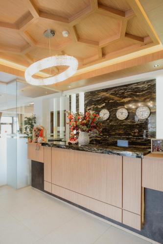 a kitchen with a counter with clocks on the wall at Radsor Hotel in Râşnov