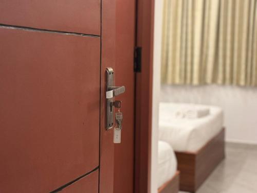 a red door in a bathroom with a sink at Le Poshe Beachview in Pondicherry