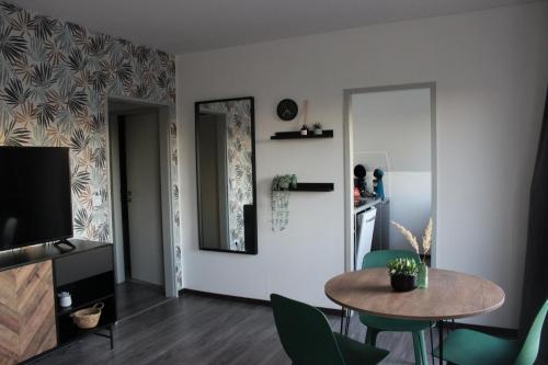 a living room with a table and chairs and a mirror at No2 by 21 Apartments in Kaarst