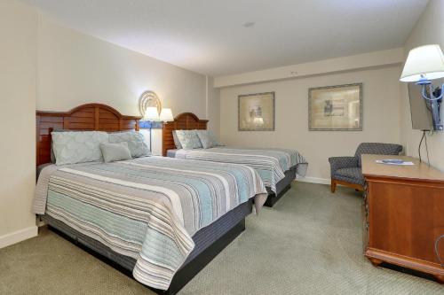 a hotel room with two beds and a desk at 2501 S Ocean Blvd, 1115 - Ocean View Sleeps 8 in Myrtle Beach