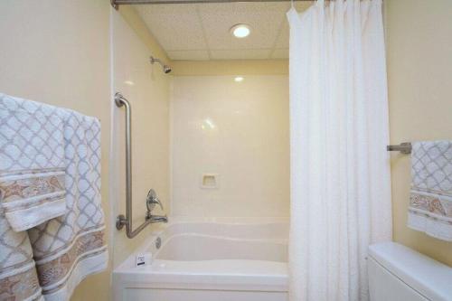 a bathroom with a tub and a white shower curtain at 2501 S Ocean Blvd, 1115 - Ocean View Sleeps 8 in Myrtle Beach