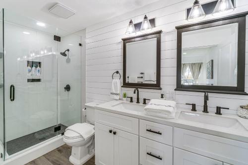 a white bathroom with a sink and a shower at Charming San Antonio Home about 2 Mi to The Alamo! in San Antonio