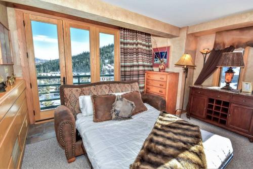 a bedroom with a bed and a window at Spectacular Views, Pool, Hot Tub, Mountain Village in Big Sky