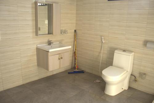 a bathroom with a toilet and a sink at Havana Comfort in Dar es Salaam