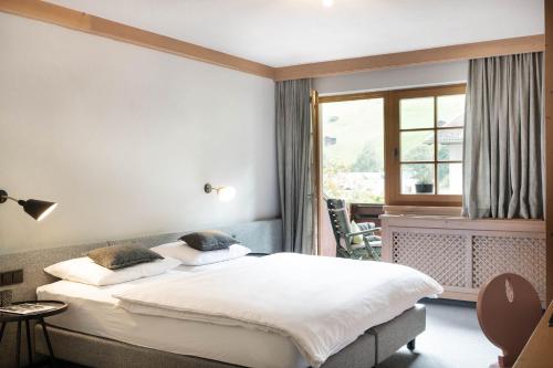 a bedroom with a large bed and a window at Schönherr Haus in Neustift im Stubaital