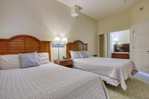 a bedroom with two beds and a television at 2501 S Ocean Blvd, 1205 - Ocean Front Sleeps 6 in Myrtle Beach