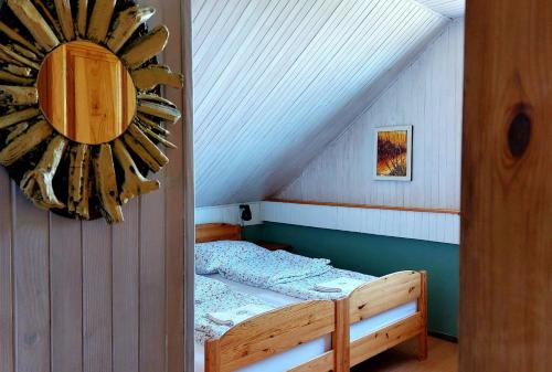 a small room with a bunk bed in a attic at Pod Małym Jasłem in Cisna