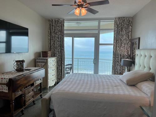 a bedroom with a bed and a desk and a window at 2501 S Ocean Blvd, 0811 - Ocean Front Sleeps 8 in Myrtle Beach
