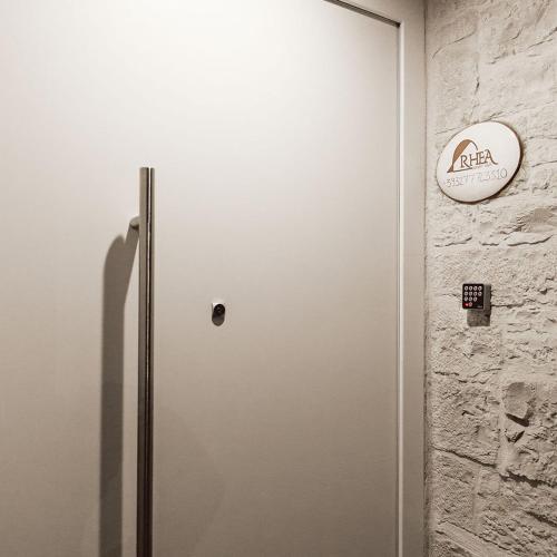 a door in a room with a sign on a wall at B&B Rhea Luxury in Terlizzi