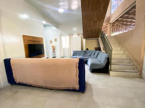 a bedroom with a large bed and a staircase at Casa de Campo Sol & Luz in Campina Grande do Sul