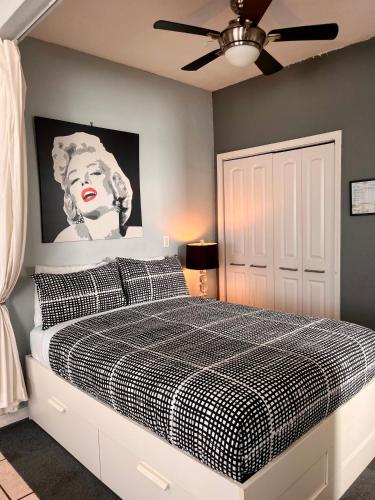 a bedroom with a bed with a black and white checkered blanket at Ocean Dream in Miami Beach