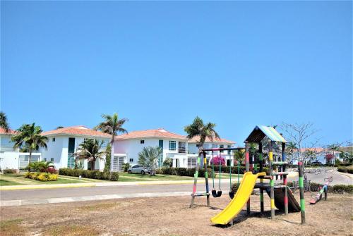 un parque infantil frente a una casa con tobogán en Villa En La Playa Cartagena #1, en Cartagena de Indias