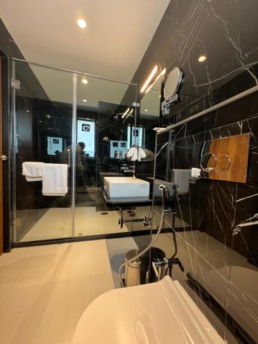 a bathroom with a sink and a mirror at Hotel Mumbai House, Malad in Mumbai