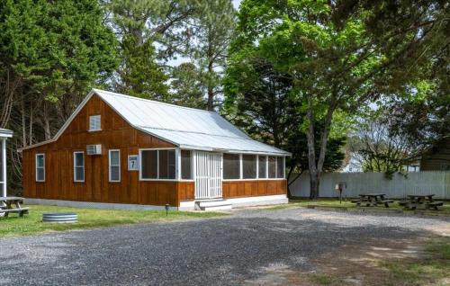a large wooden barn with a metal roof at Beach Bum West-O Cabins in Ocean City