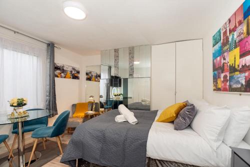 a bedroom with a bed and a living room at Chic Studio Apartment, Bus 18 to Euston in 30 min. in London
