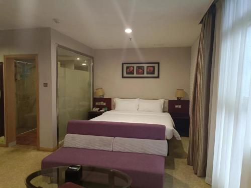 a hotel room with a bed and a couch at Guangdong Baiyun City Hotel in Guangzhou