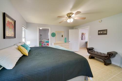 a bedroom with a bed and a ceiling fan at Cozy Bandera Cottage with Medina River Access! in Bandera